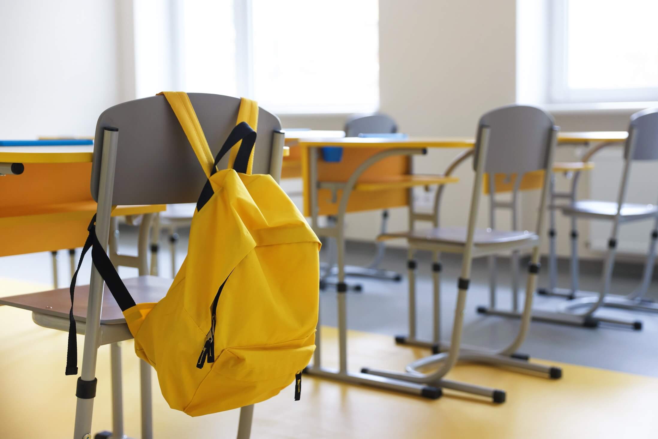 Chair,With,Backpack,Near,Desk,In,Classroom,At,School,,Selective
