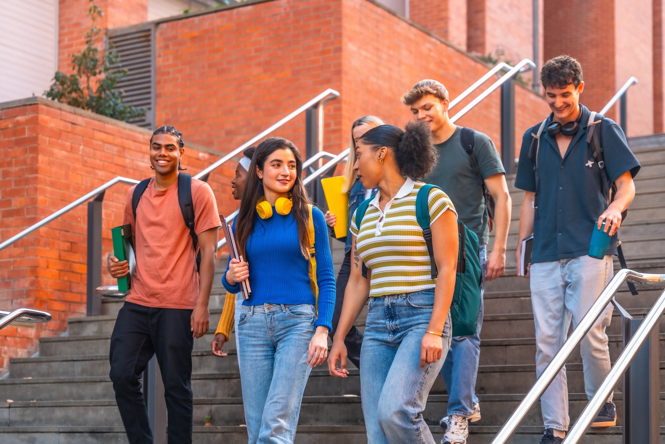 Diverse,Group,Of,Smiling,University,Students,Walking,Down,Outdoor,Stairs