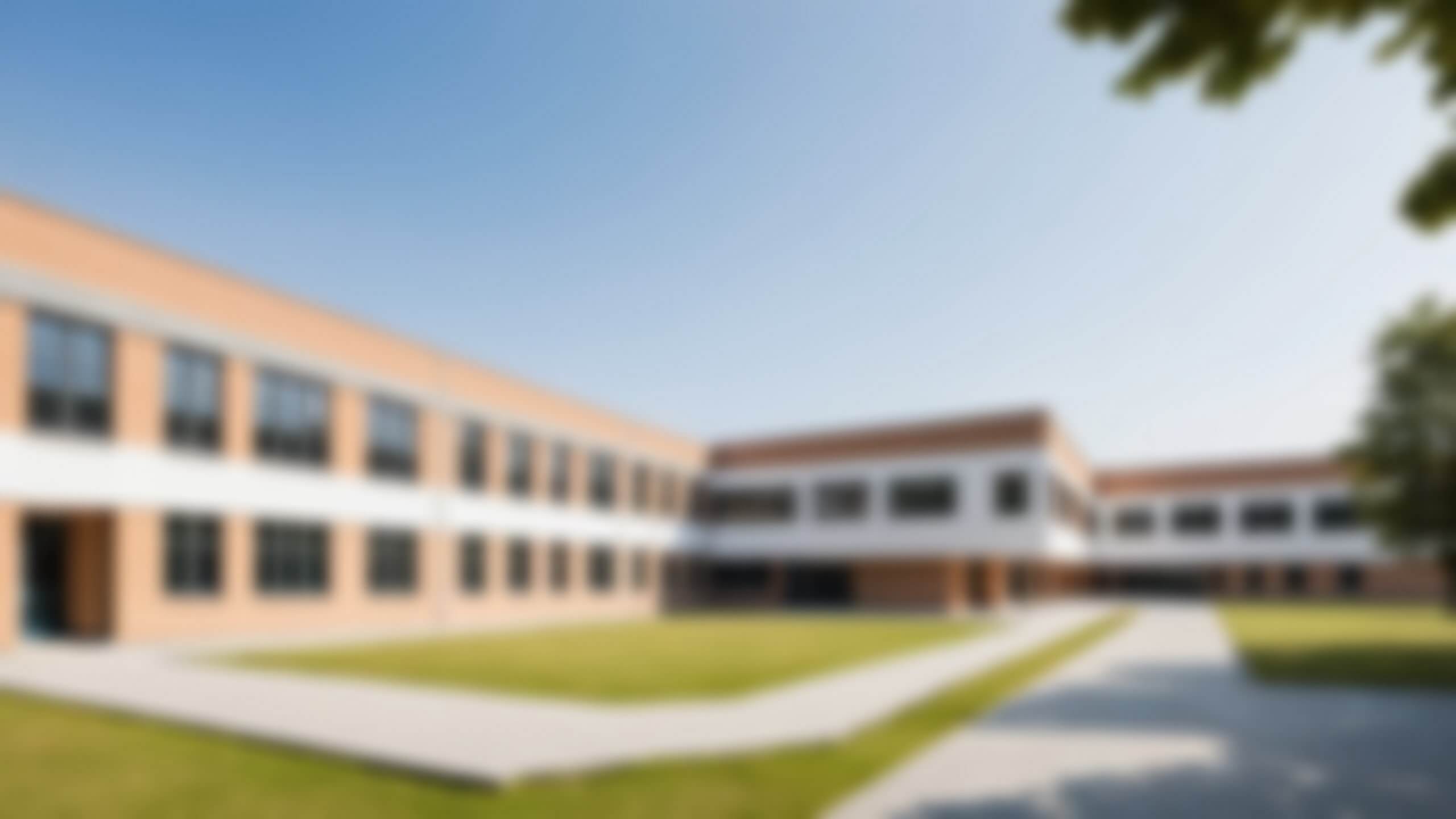 Blur,Image,Of,A,Modern,High-rise,School,Building,,Large,Yard,